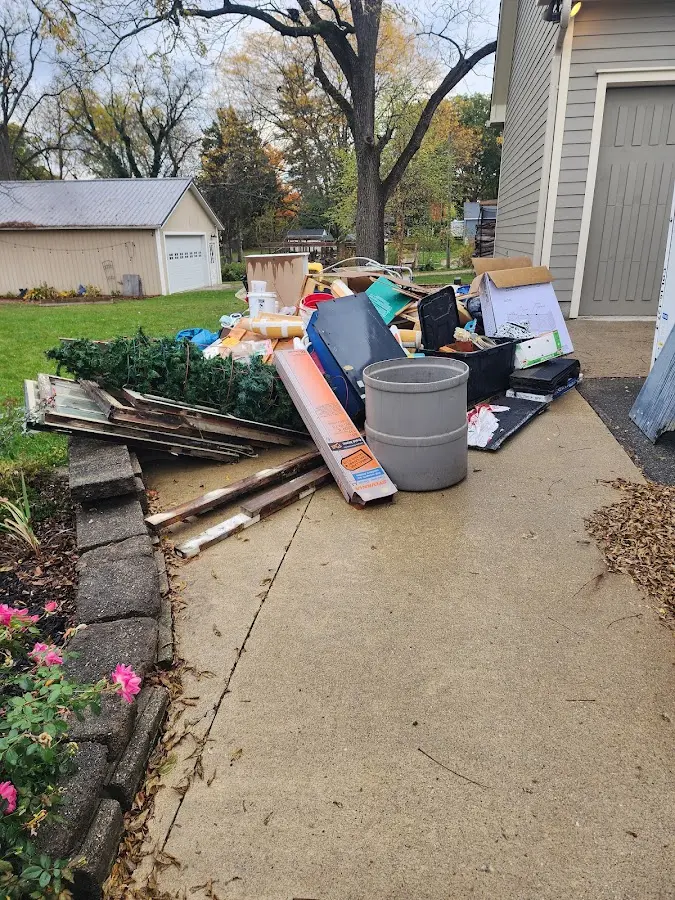 Dumpster being loaded with debris for 10 Yard Dumpster Rental in Soddy-Daisy